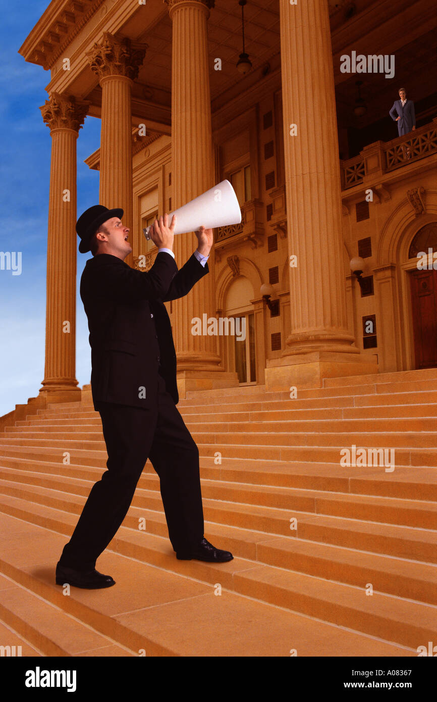 Businessman shouting through megaphone Stock Photo