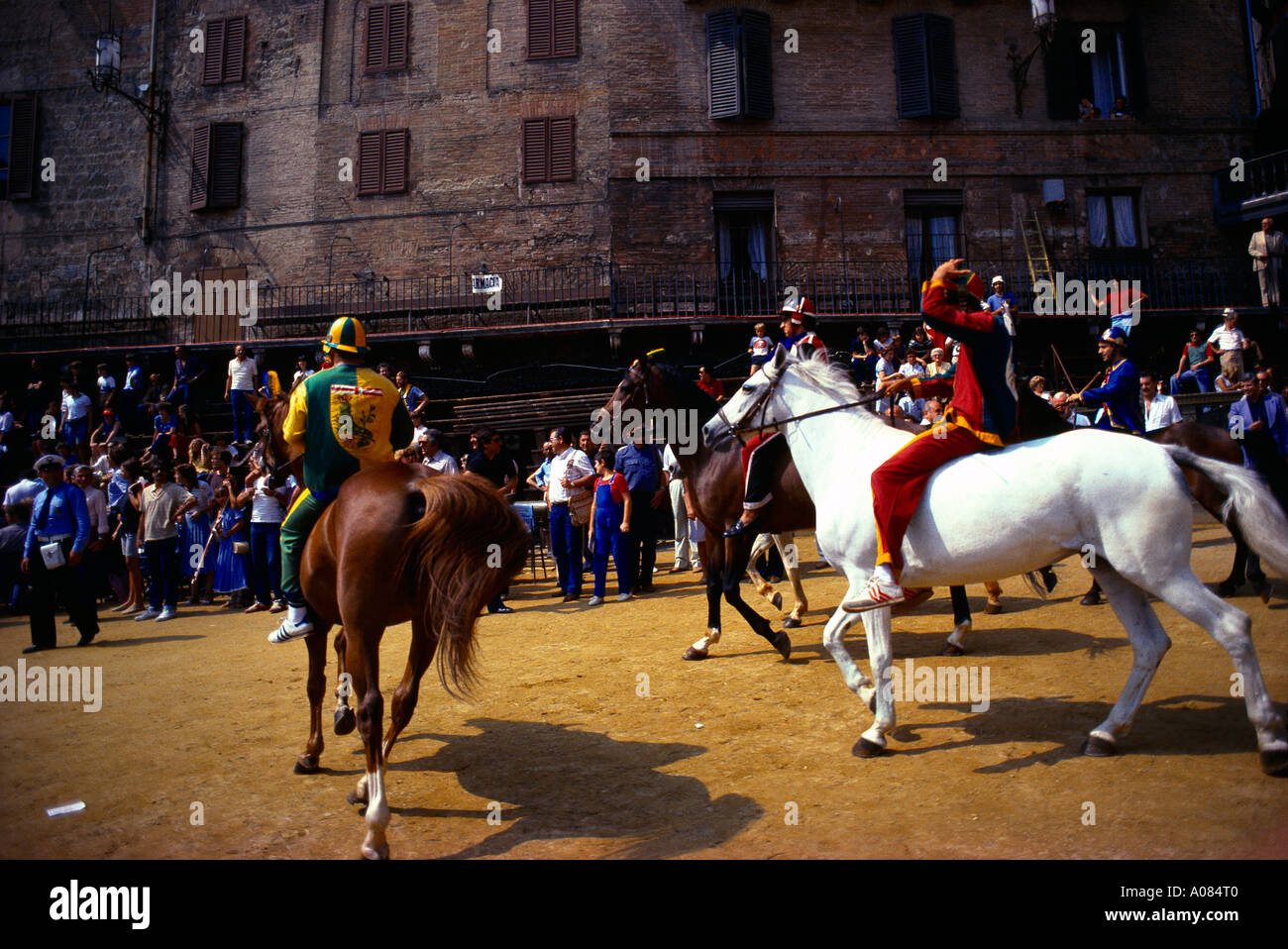 Siena Italy Tourists and Locals watching the Palio di Siena a Horse Raceheld twice a year at the Piazza Del Campo each Jockeys Represents One of the T Stock Photo