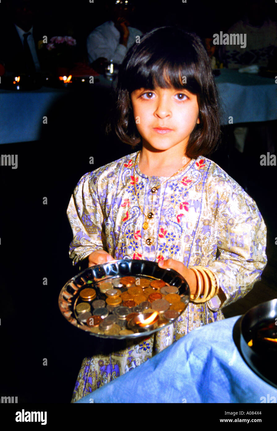 Girl holding a puja tray with  money Performing Chopda Puja During Diwali Signifying the Start of the new Financial year in the Hindu Calendar Stock Photo