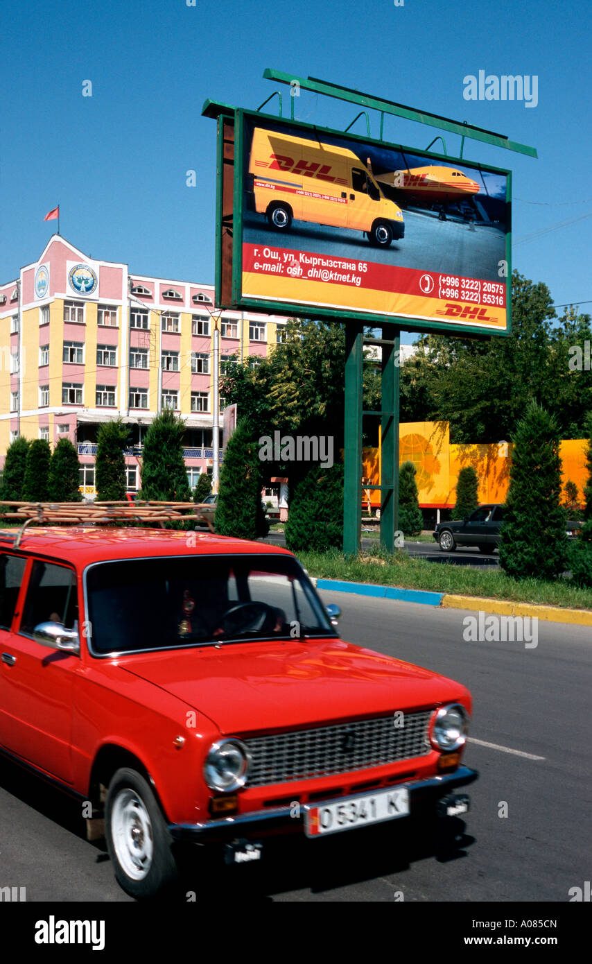June 4, 2006 - Russian made Lada passes a billboard advertising the services of DHL in the Kyrgyz city of Osh. Stock Photo
