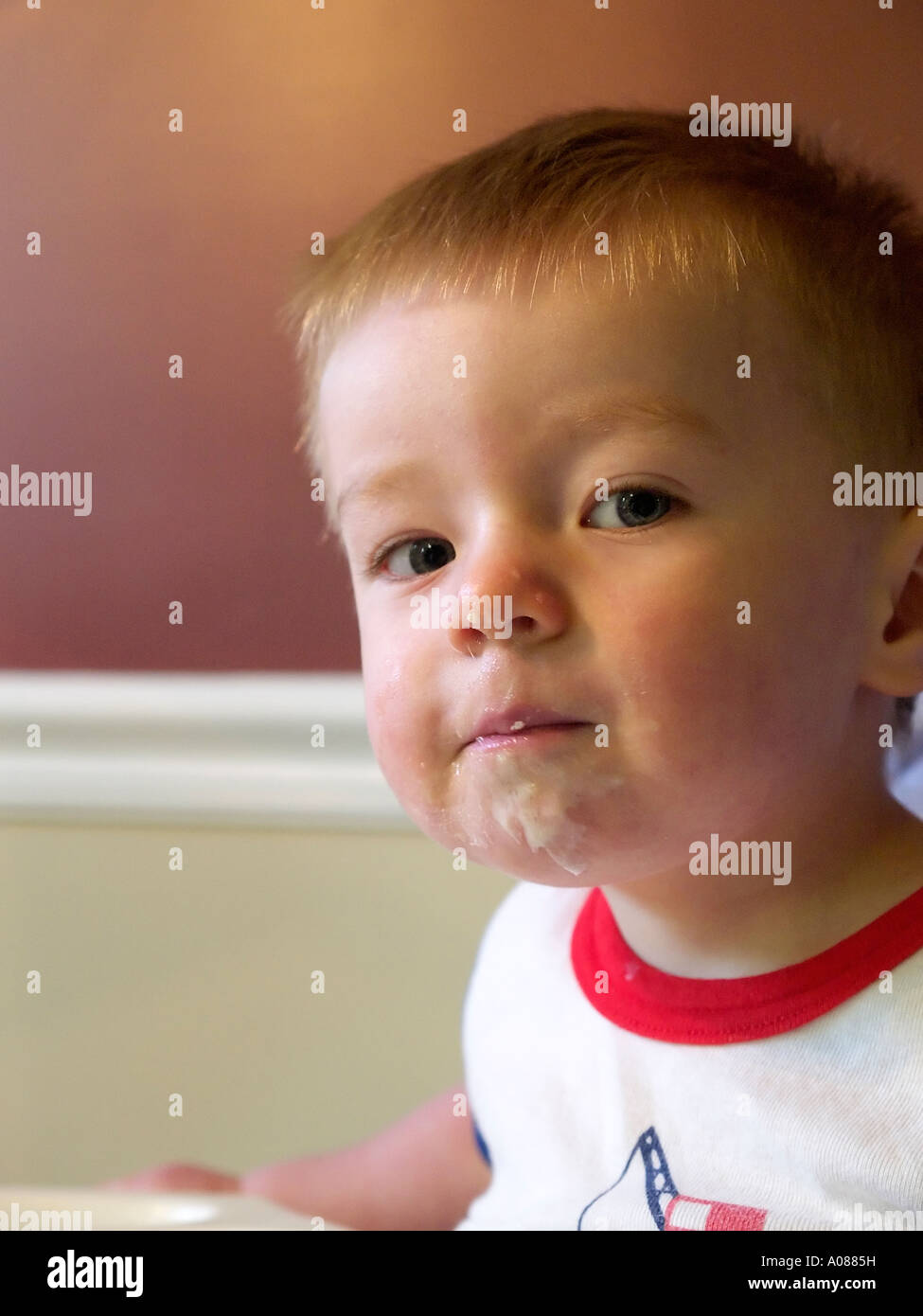 Toddler eating breakfast and getting a little messy while doing it Stock Photo