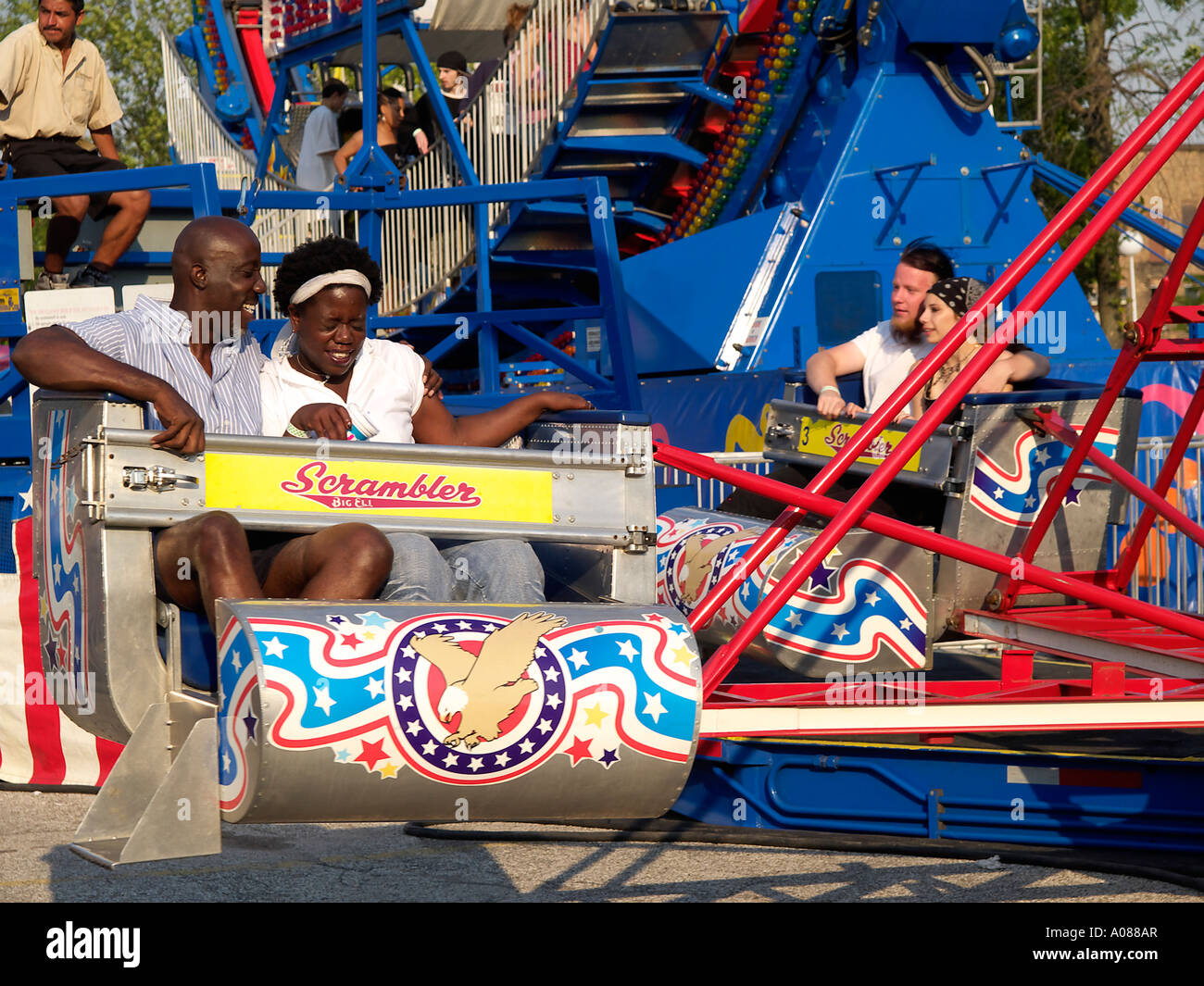 African American Couple Ride The Scrambler He Appears To Be Having A Lot Of Fun Watching His Anxious Partner Stock Photo Alamy