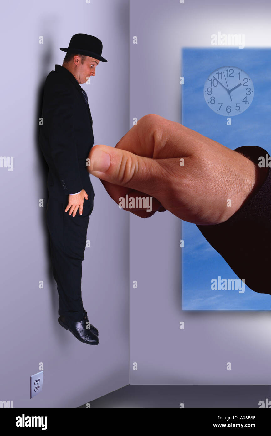 Businessman pushed against wall with thumb Stock Photo - Alamy