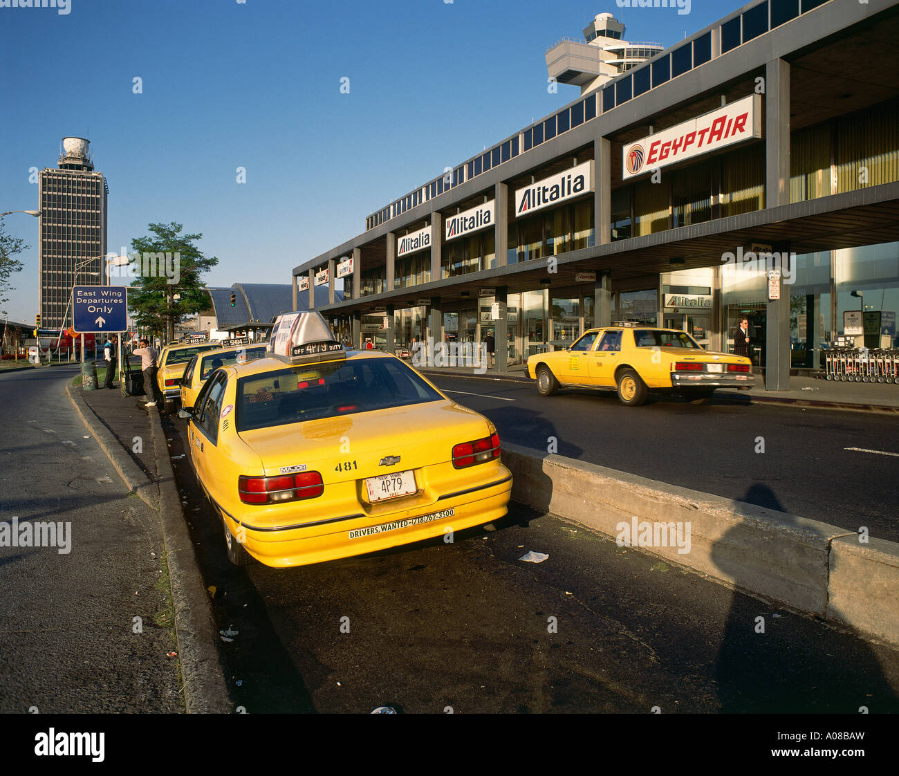 Distinctive yellow taxi cabs parked at ranks outside Terminal 2 at the John F Kennedy