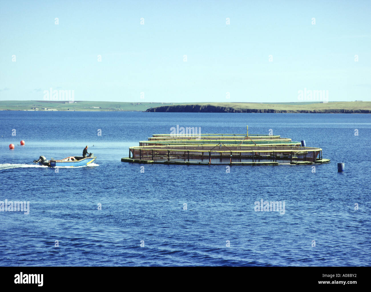 dh Norquay Fish Farm ORKNEY SALMON ORKNEY Boat arriving at fish cages farmer Stock Photo