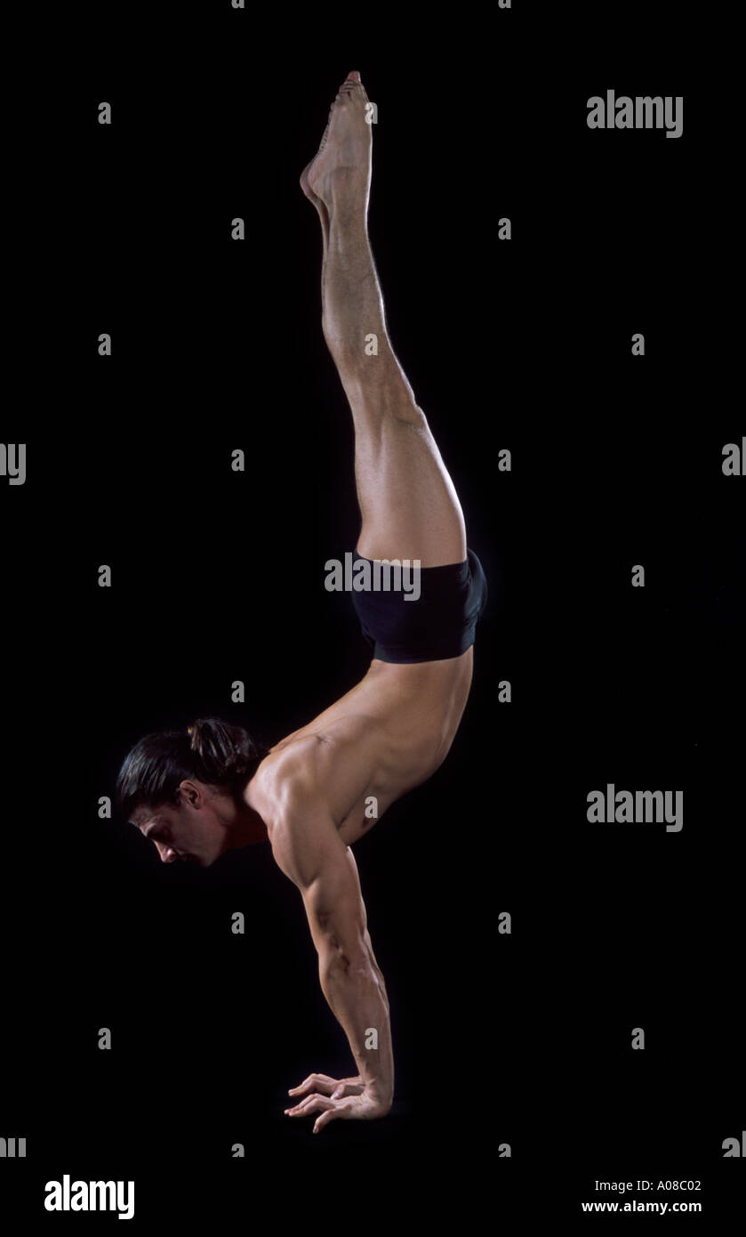 acrobat balancing on his hands Stock Photo - Alamy