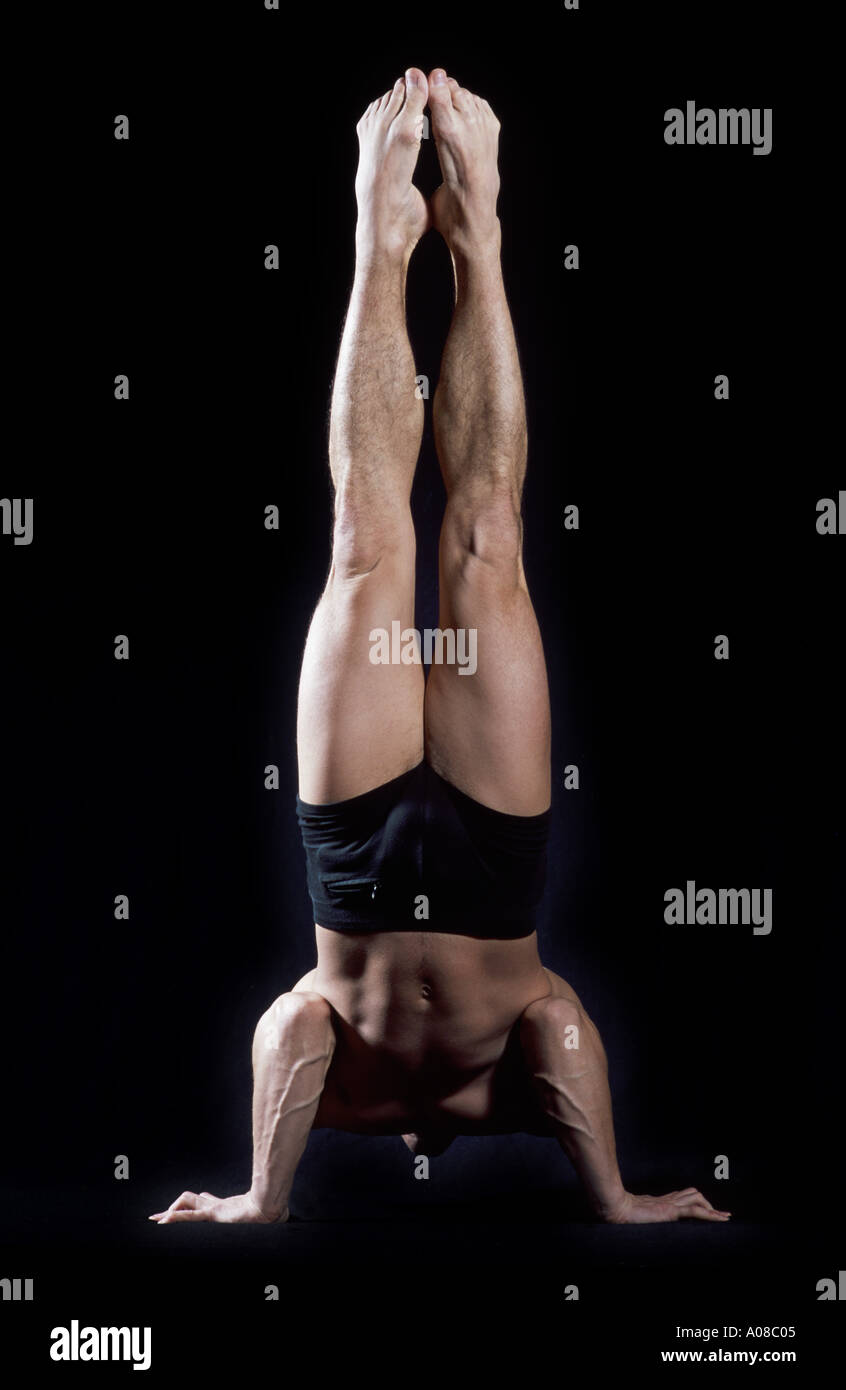 acrobat balancing on his hands Stock Photo