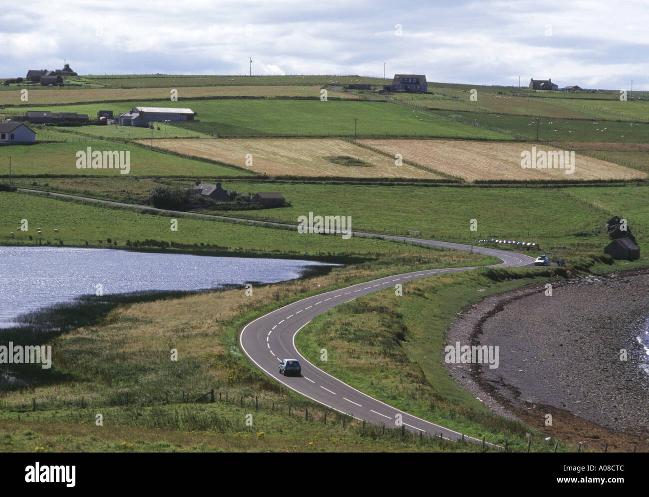 dh Echna Loch BURRAY ORKNEY Car on road by Echna Loch travelling countryside motorcar scotland Stock Photo