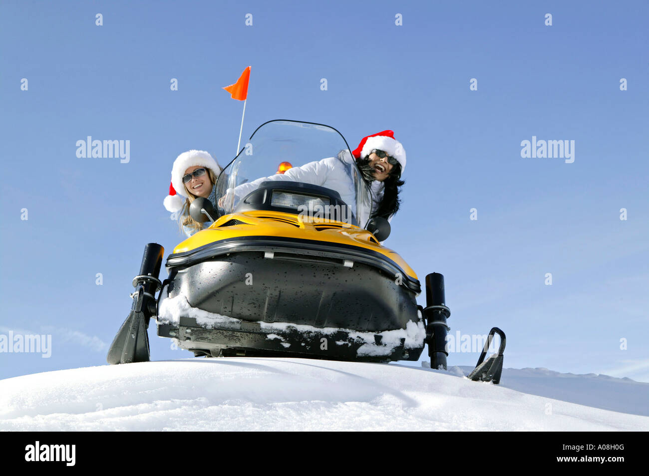 Zwei Frauen unterwegs mit einem Snowmobil, two women on snowmobile, skiscooter Stock Photo
