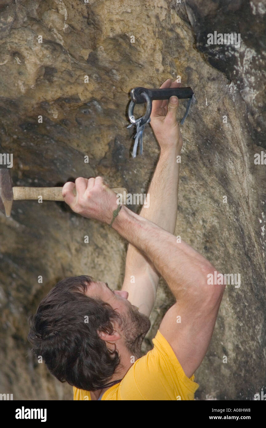 Rock Climber hitting drill with hammer while hand drilling a protection  bolt Stock Photo - Alamy