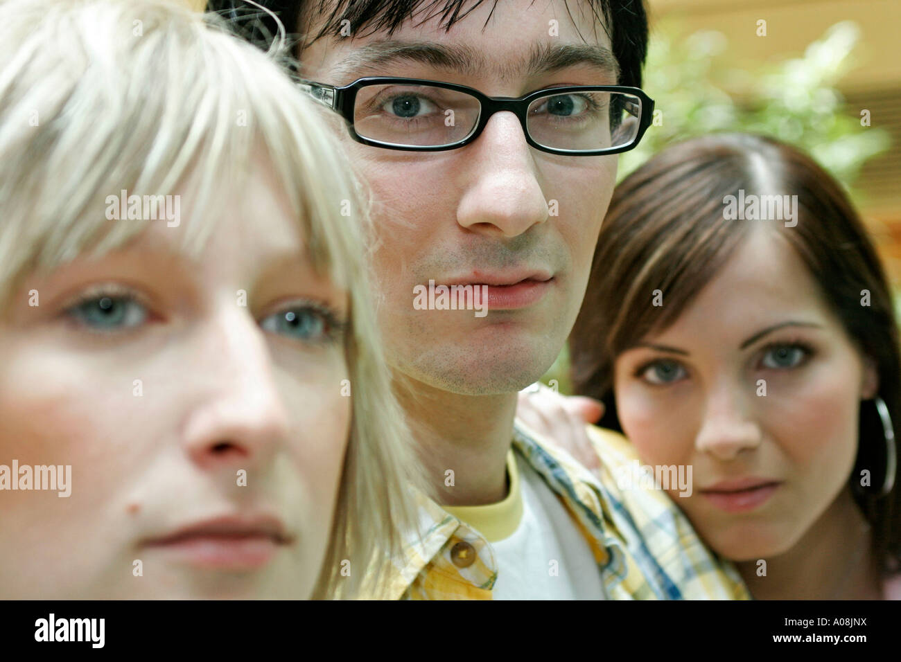 Junger Mann und zwei Frauen, young man with two woman portrait Stock Photo