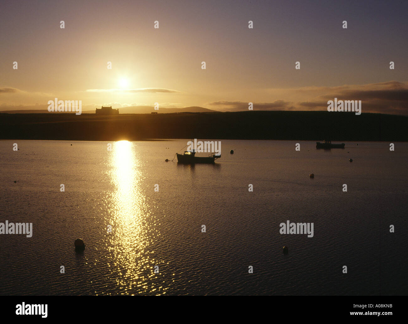 dh  STROMNESS ORKNEY Sunrise over House and fishing boat in Hamnavoe tranquil Stock Photo