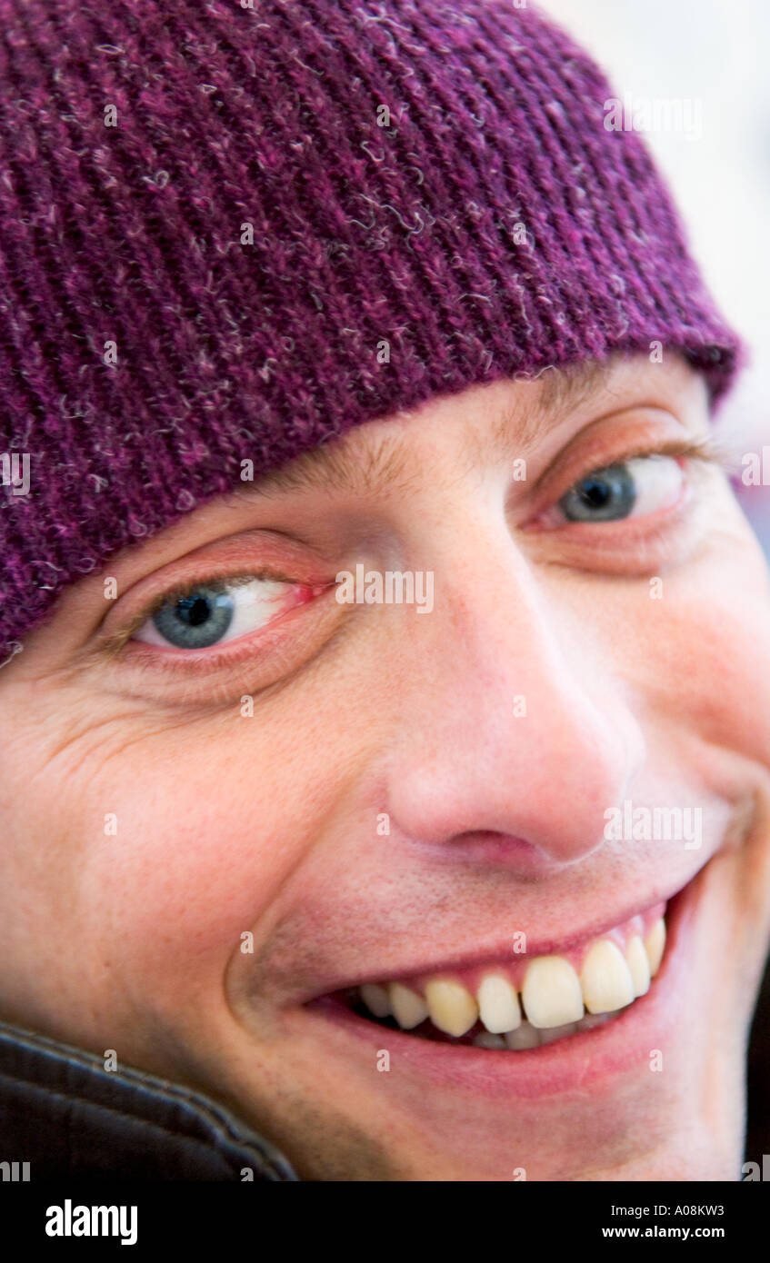 caucasian man wearing wool cap smiles into camera Stock Photo