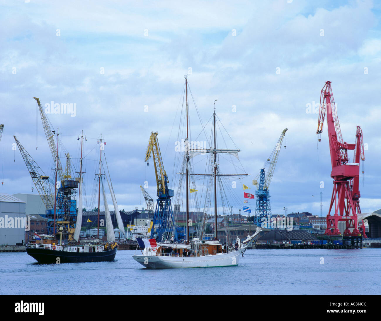 Two tall ships sailing down the River Tyne at the start of a Tall Ships
