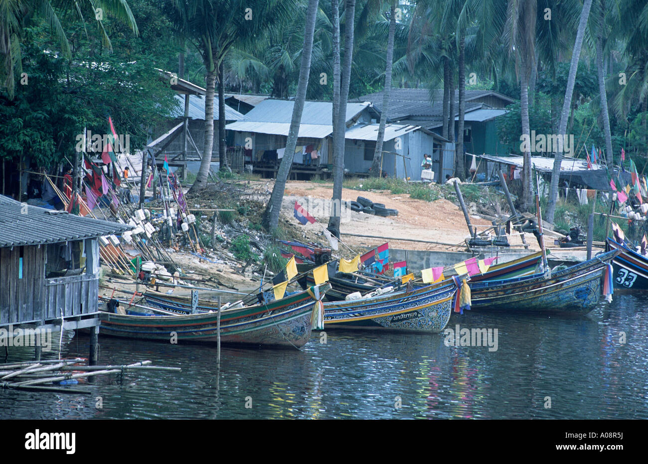 Boats moored along the banks at Saiburi Stock Photo