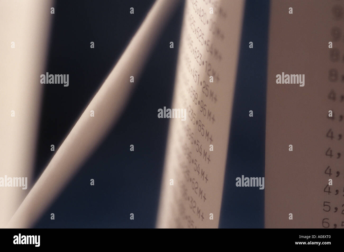 Adding machine tape abstract spiraling endless rows of large numbers ...