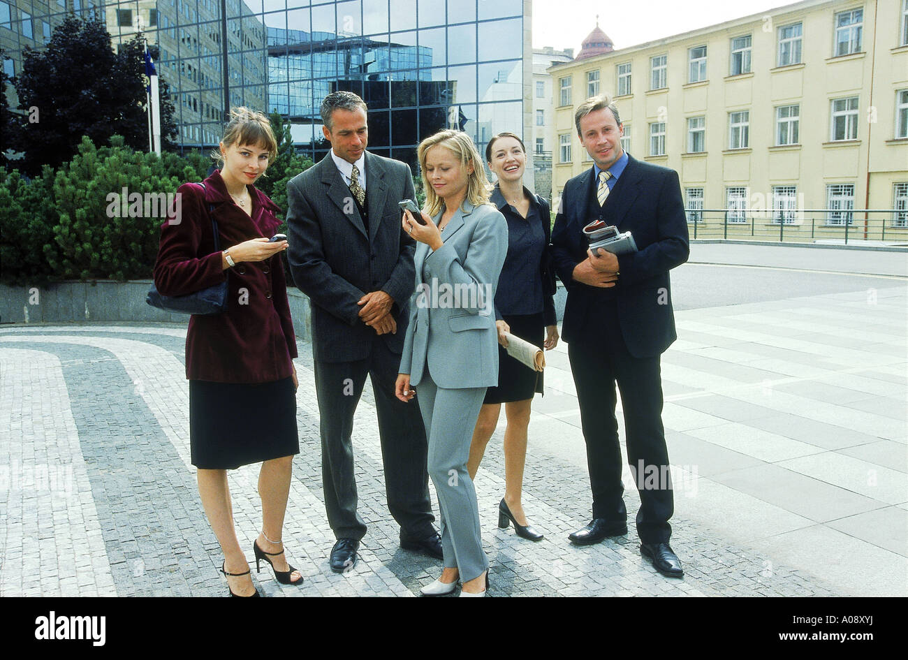 Group of business executives standing together outdoors Stock Photo - Alamy