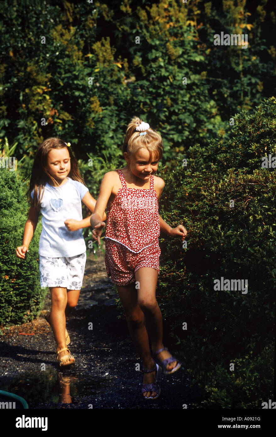 Two girls running in the woods Stock Photo Alamy