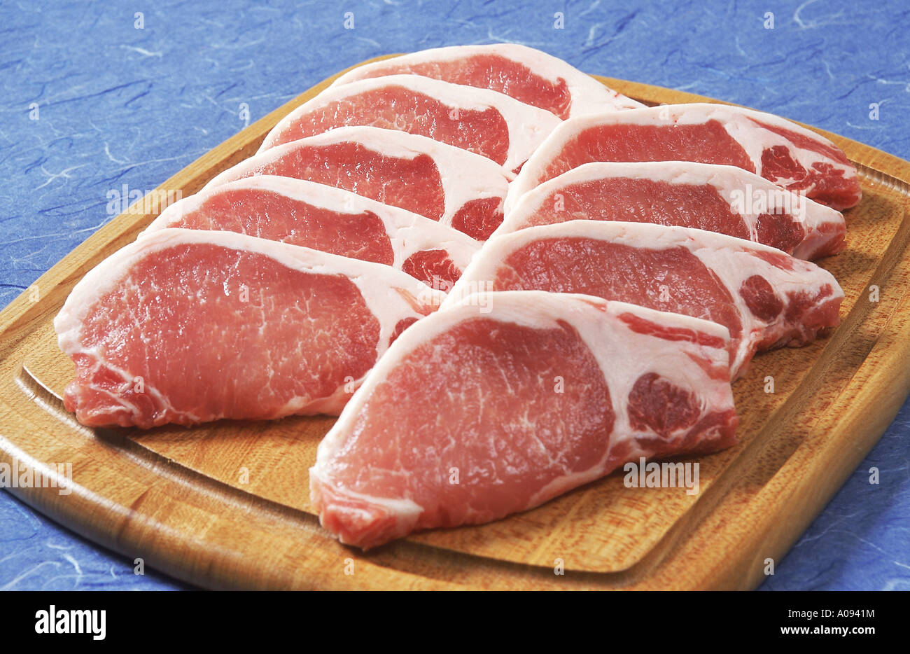 uncooked-pork-chops-on-cutting-board-stock-photo-alamy