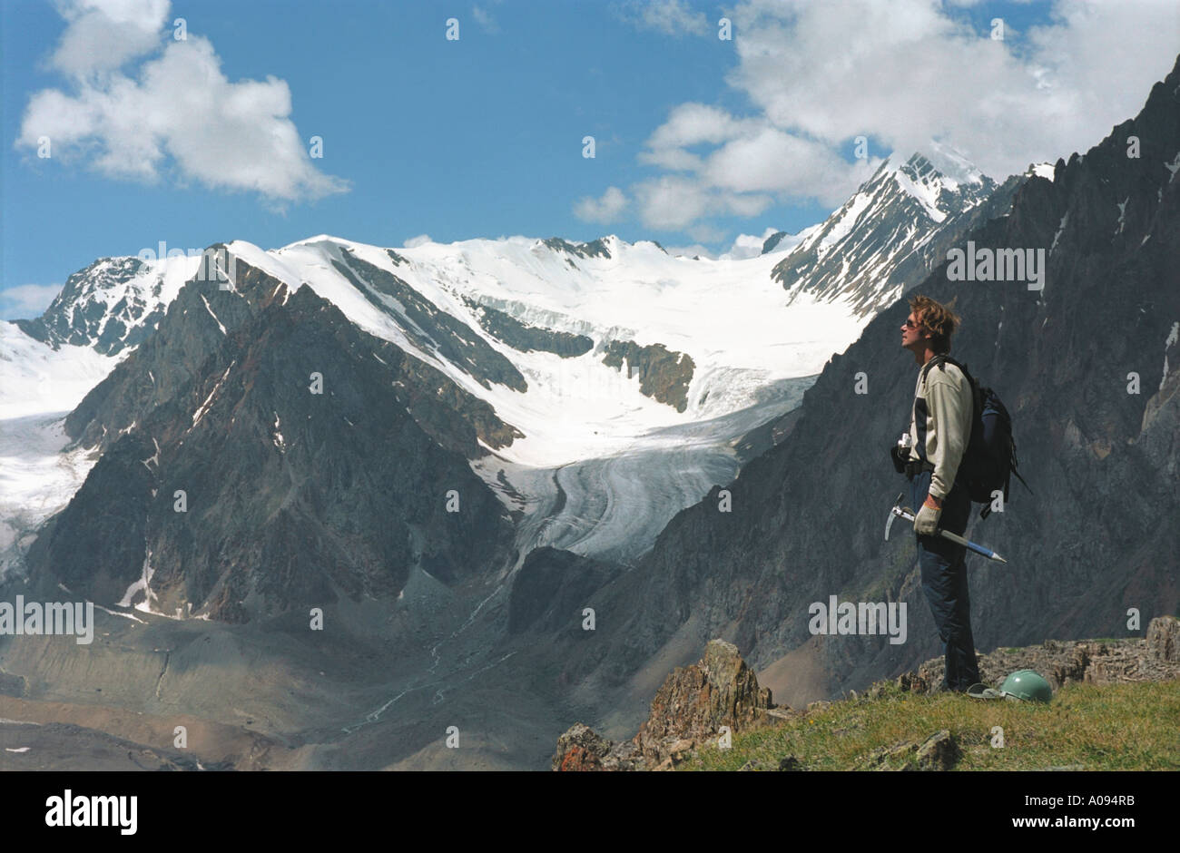 An alpinist is standing on the mountain slope above the Aktru Gorge. The Northern Chuya Range. Altai. Siberia. Russia Stock Photo