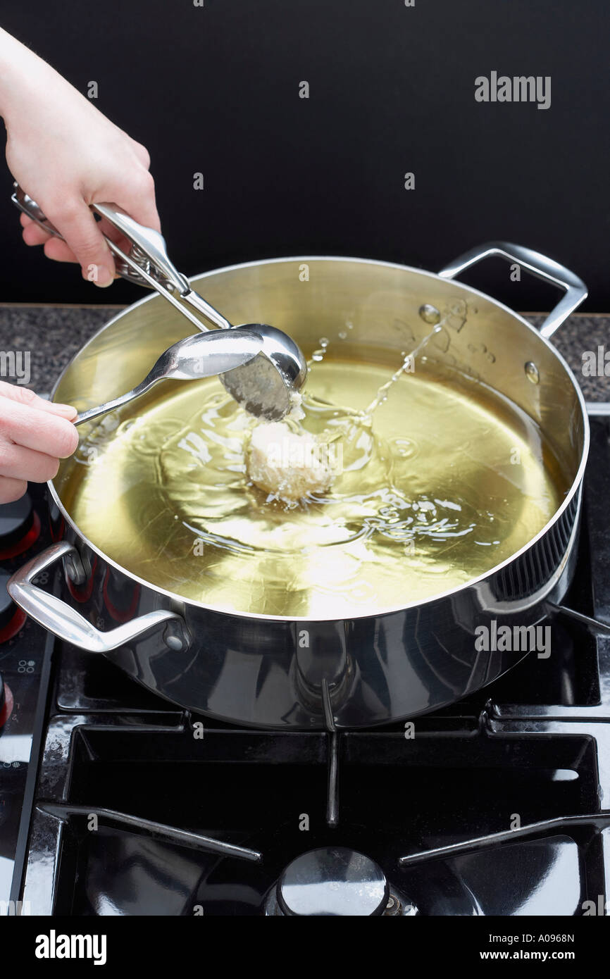 Sour Cream Doughnuts Cooking in Oil Stock Photo