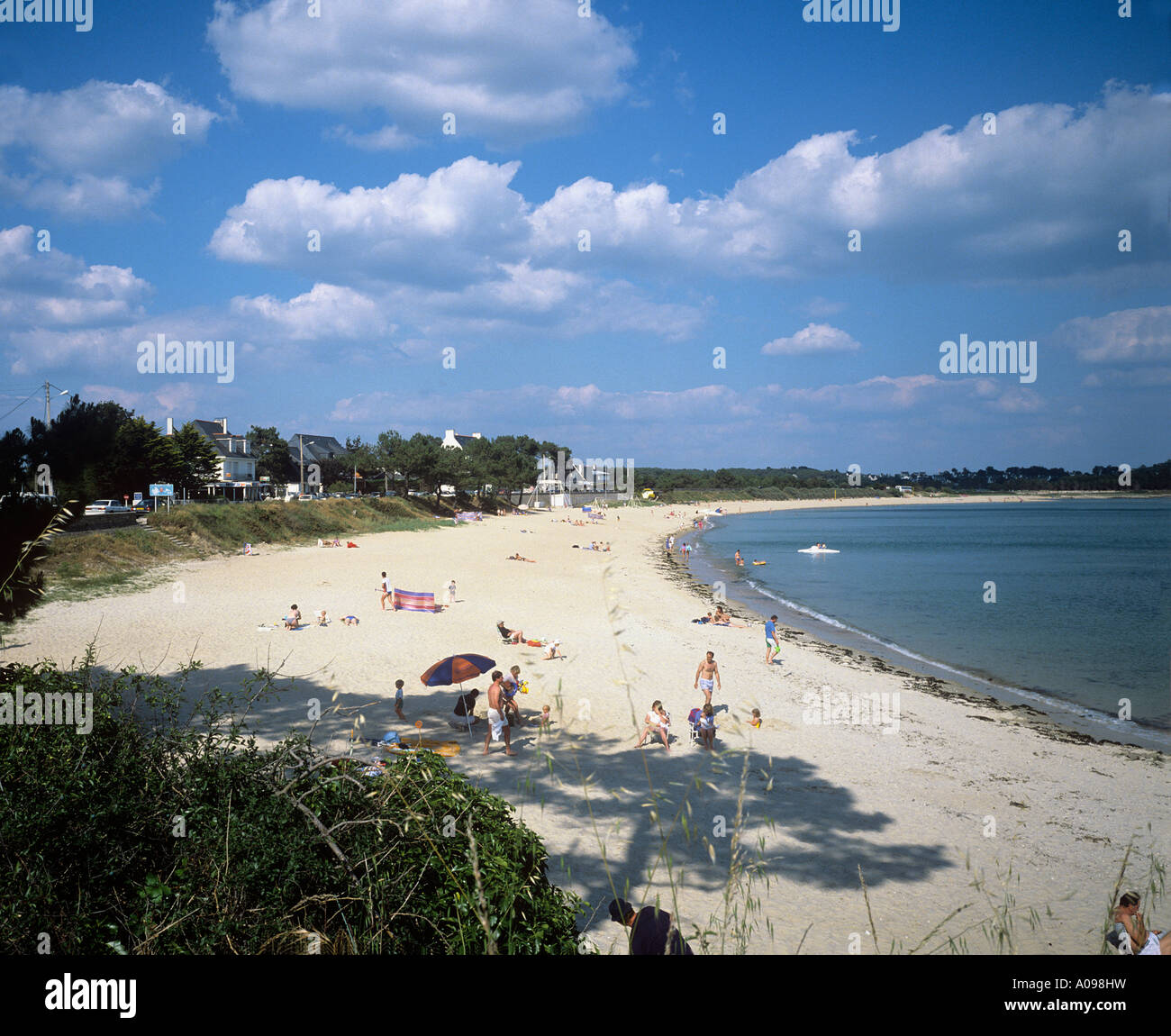wide sandy beach backed by dunes and the resort town of Carnac plage Stock Photo