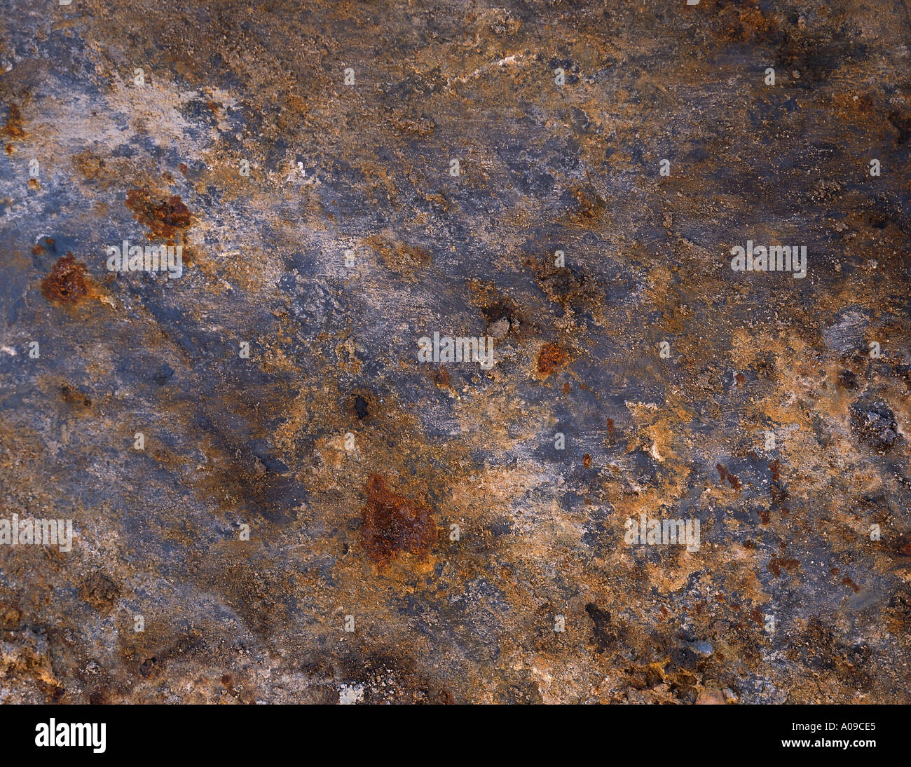 A close up of an aged and weathered rusted metal surface with chipping ...