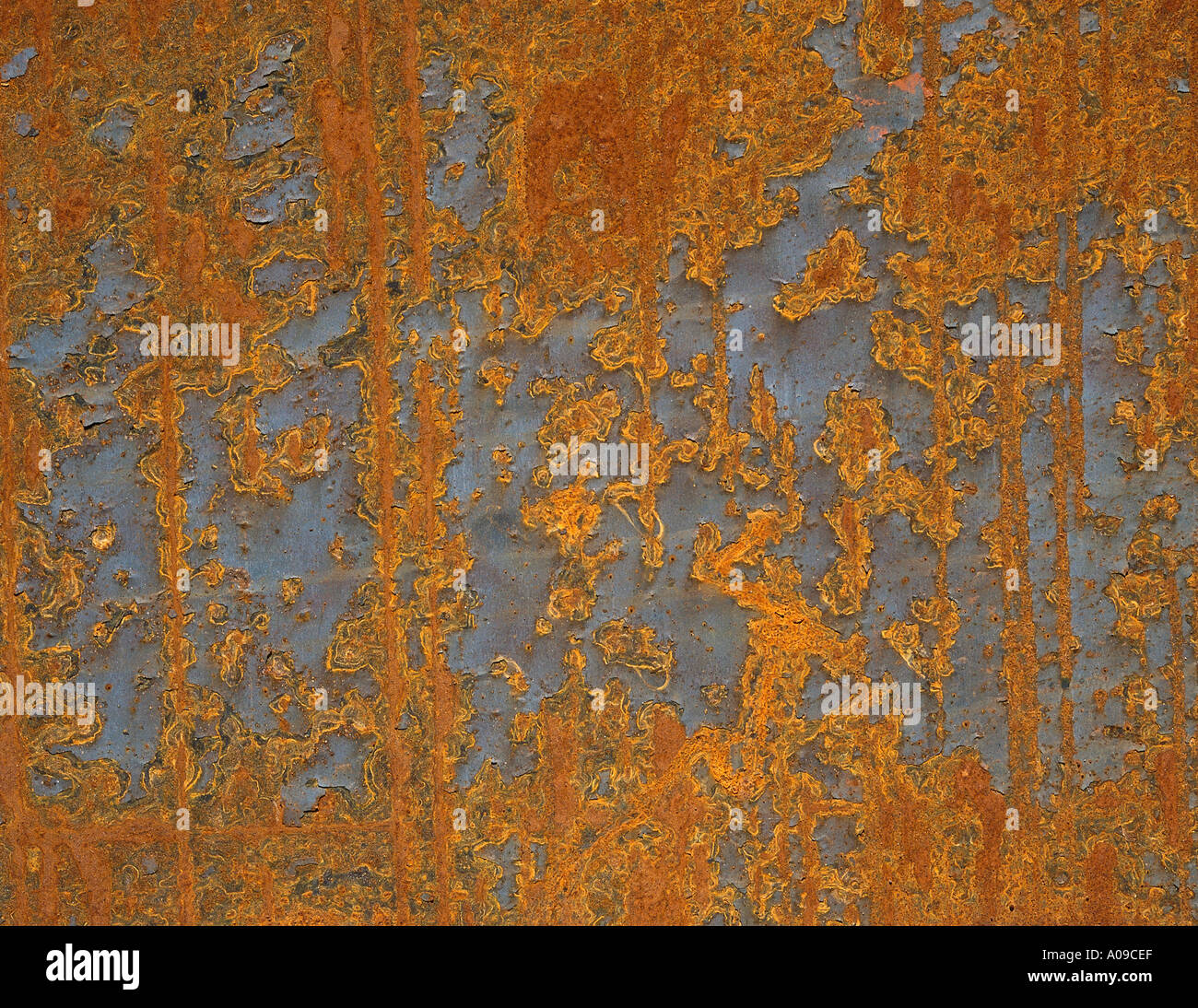 A close up of an aged and weathered peeling and flaking rusted metal ...