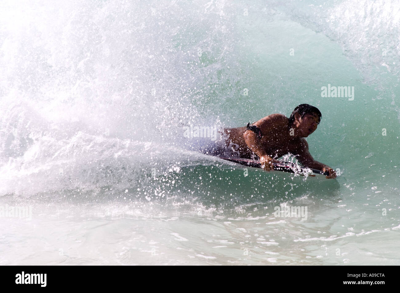 body surfer catches a wave at the body surfing beach on Oahu Hawaii