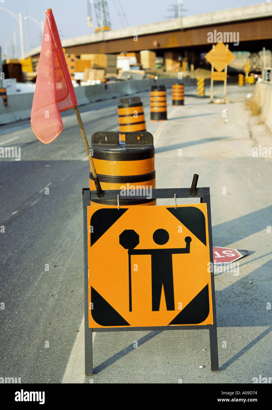 Caution traffic control person ahead sign with roadwork and