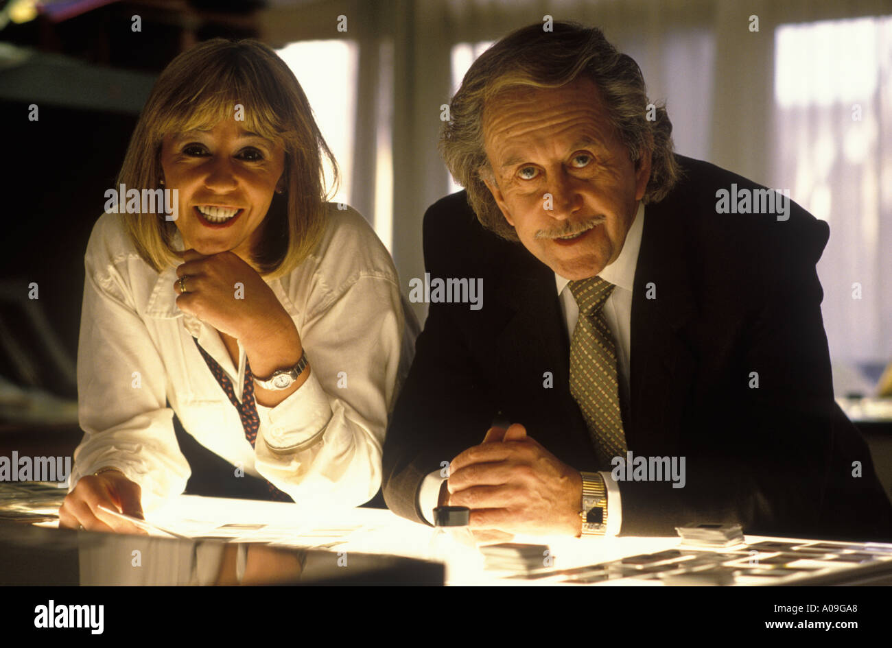Paul Raymond daughter Debbie in their Soho office London over light box looking at colour slides HOMER SYKES Stock Photo