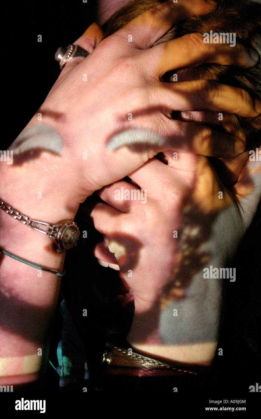Andy Warhol’s Marilyn Monroe Projected On Clenched Hands Stock Photo
