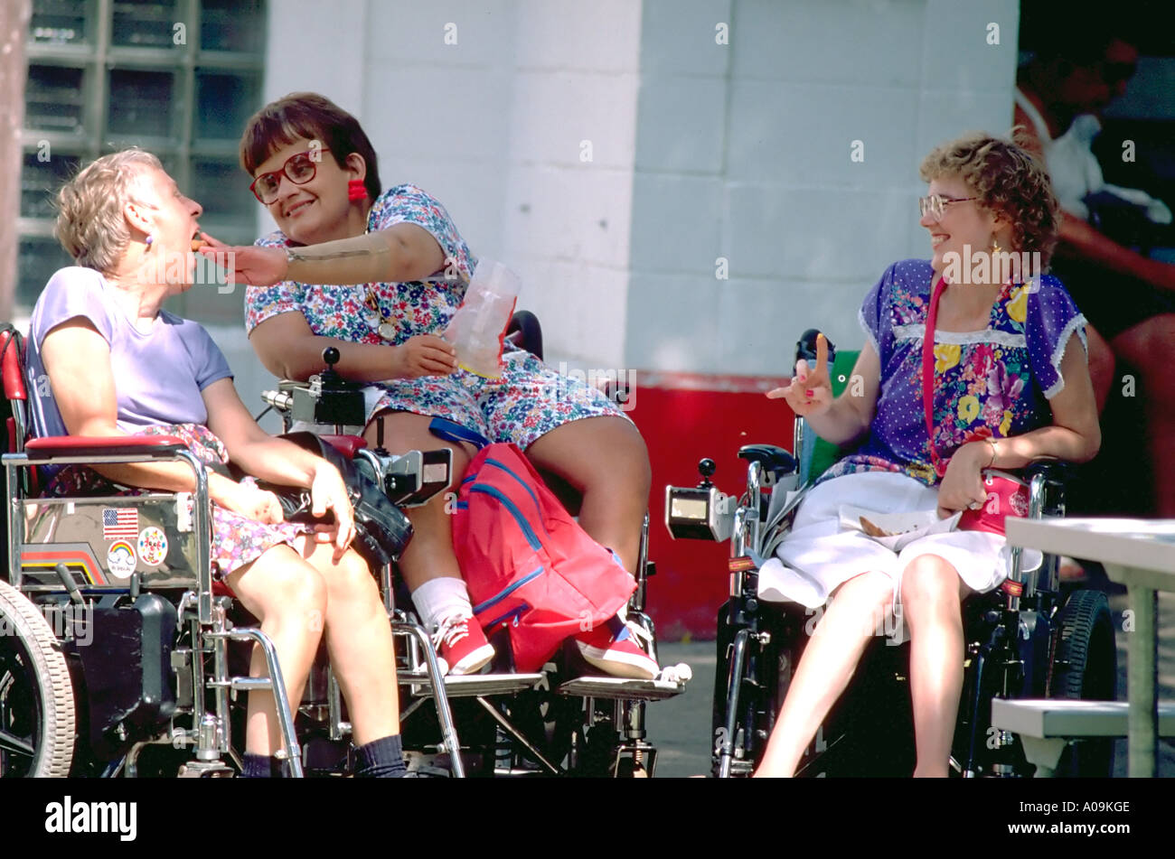 Physically handicapped women ages 45 and 60 eating at Minnesota State Fair. St Paul Minnesota USA Stock Photo