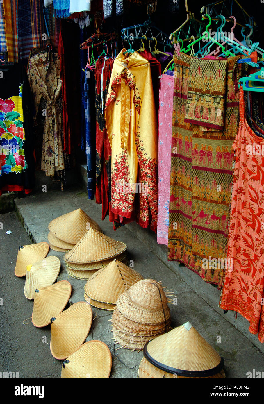 Coolie sun hata and sarongs, Candi Dasa street market, Bali Indonesia Stock Photo