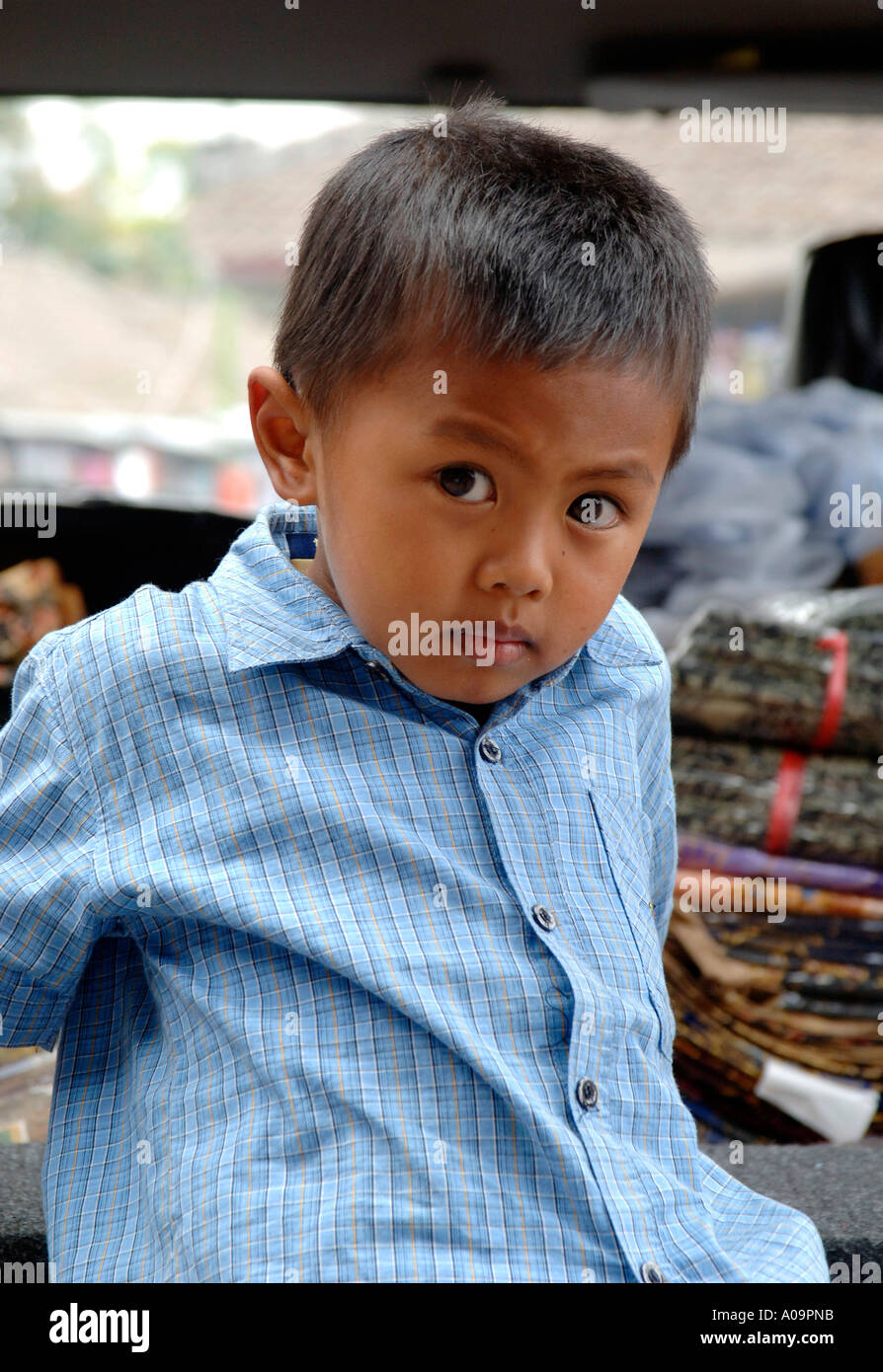 Little Indonesian boy looking pensive Stock Photo - Alamy