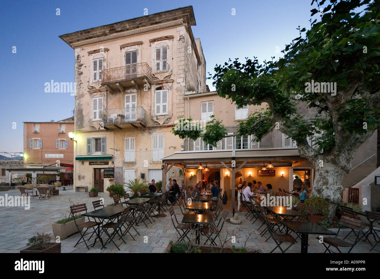Restaurant at dusk in the main square, Erbalunga, Cap Corse, Corsica, France Stock Photo