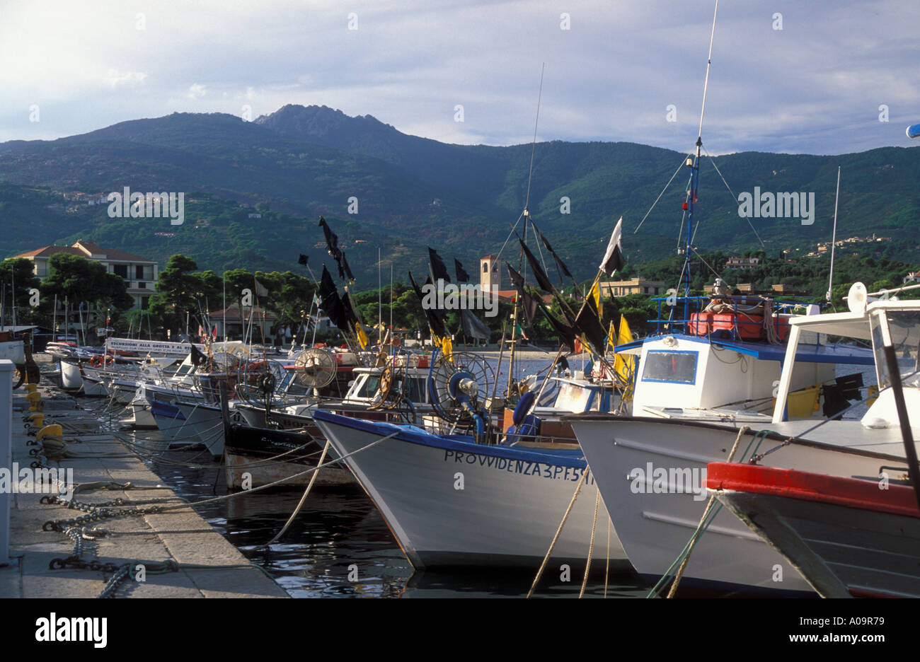 Fishingboats longliners in harbor at Marina di Campo in back Monte Capanne 1018 m Island Elba Tuscany Italy Stock Photo