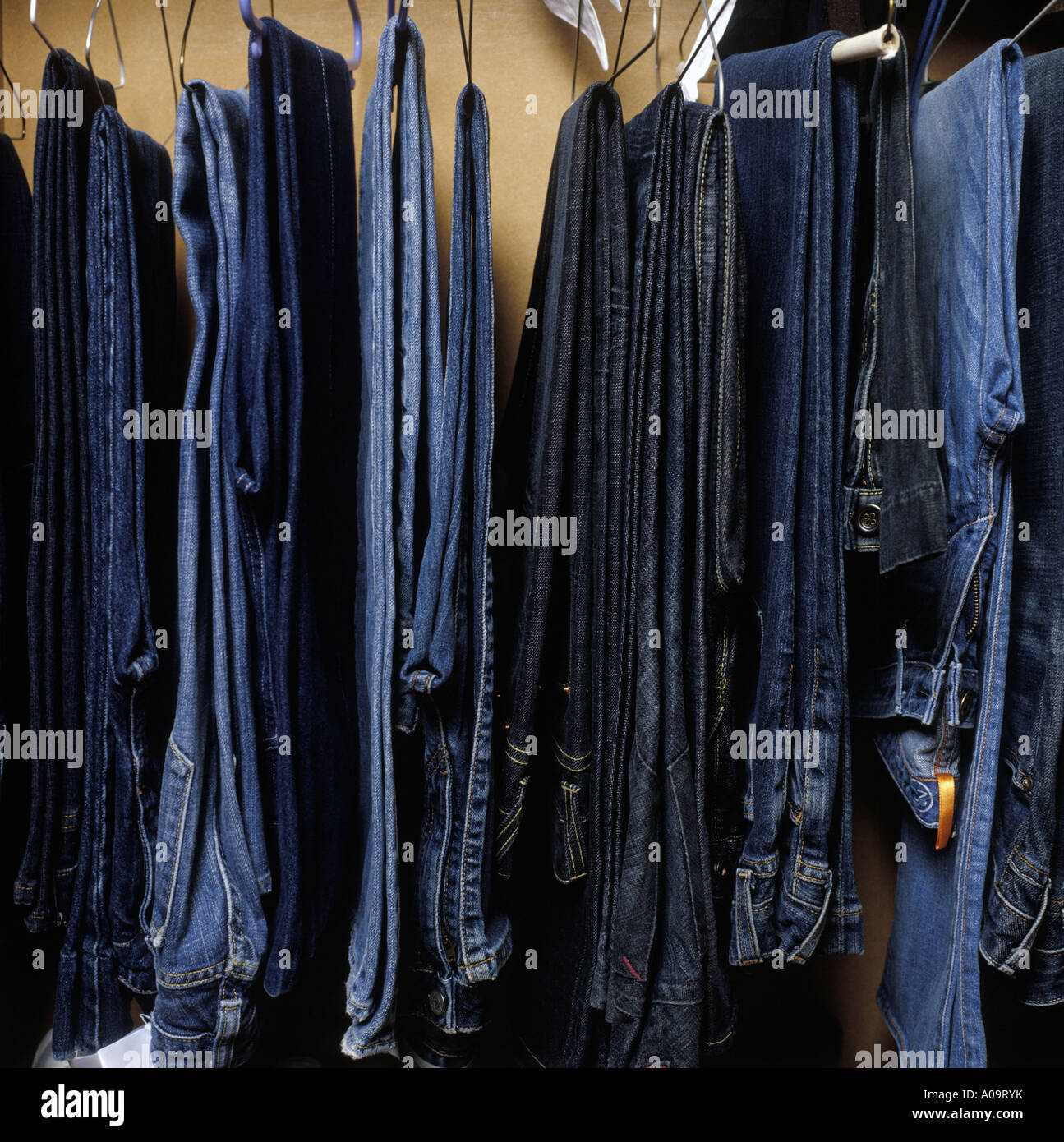 a selection of jeans hanging in a wardrobe Stock Photo