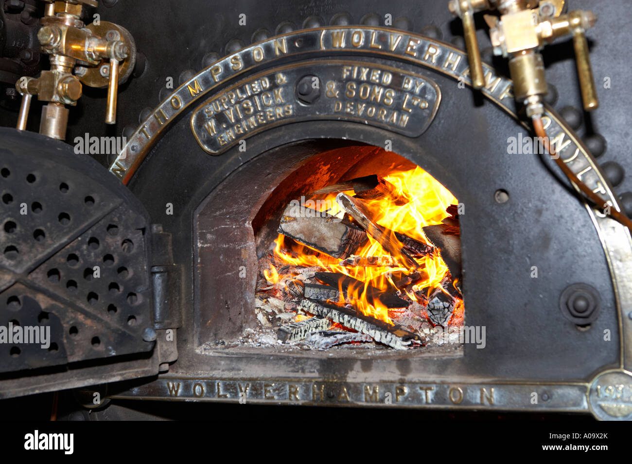 fire in a boiler raising steam for a working mill engine Stock Photo