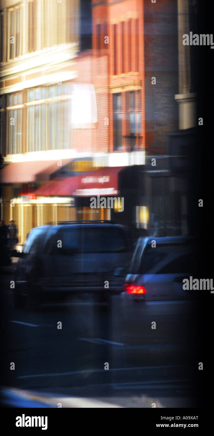 Urban reflection forms a painterly city scene with traffic and colourful buildings Stock Photo