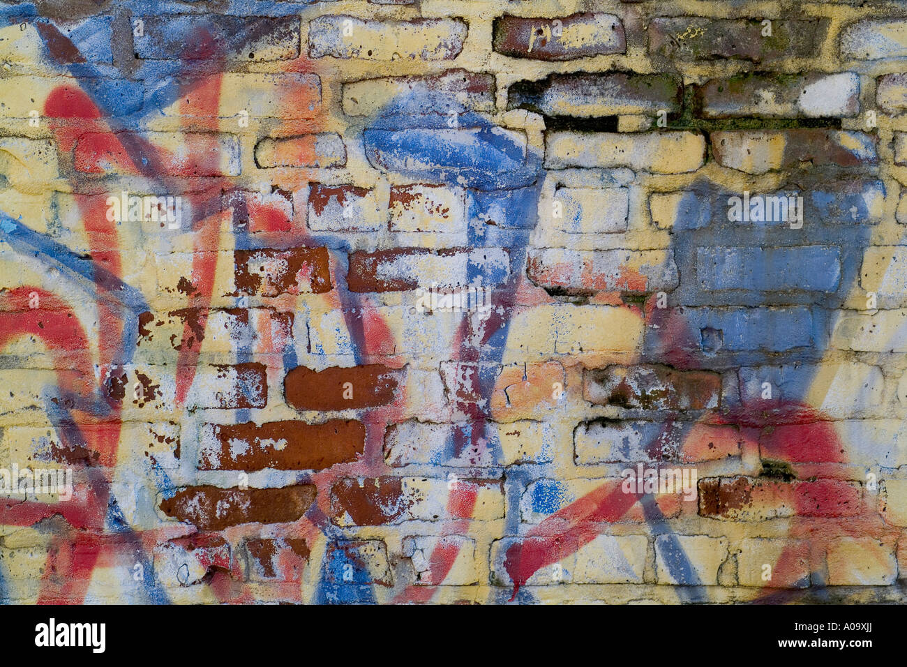 Graffiti on a brick wall forms an abstract design. Background textures and patterns Stock Photo