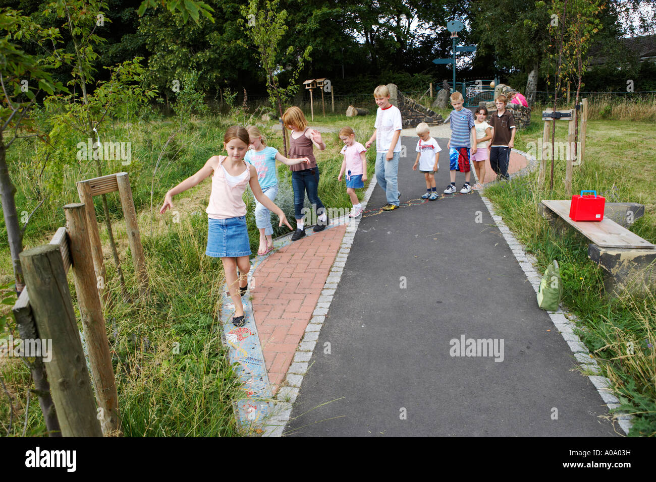 school children playing follow my leader during the lunch break Stock Photo