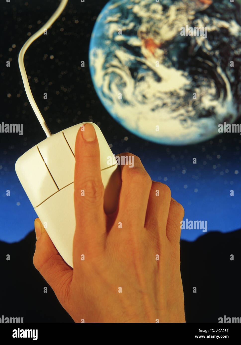 hand on mouse with Earth background Stock Photo