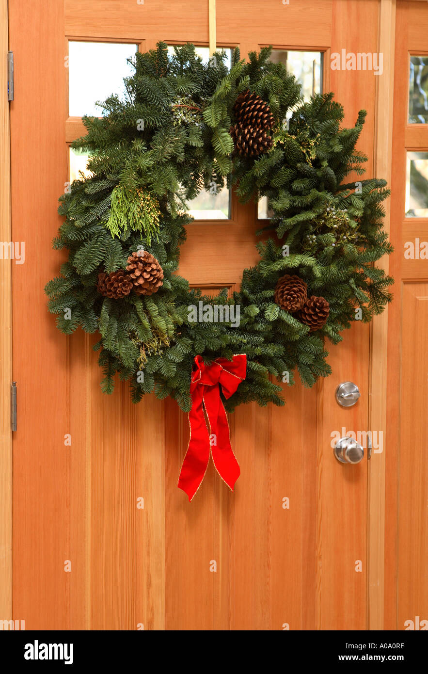 Wreath hanging on natural wood door Stock Photo Alamy