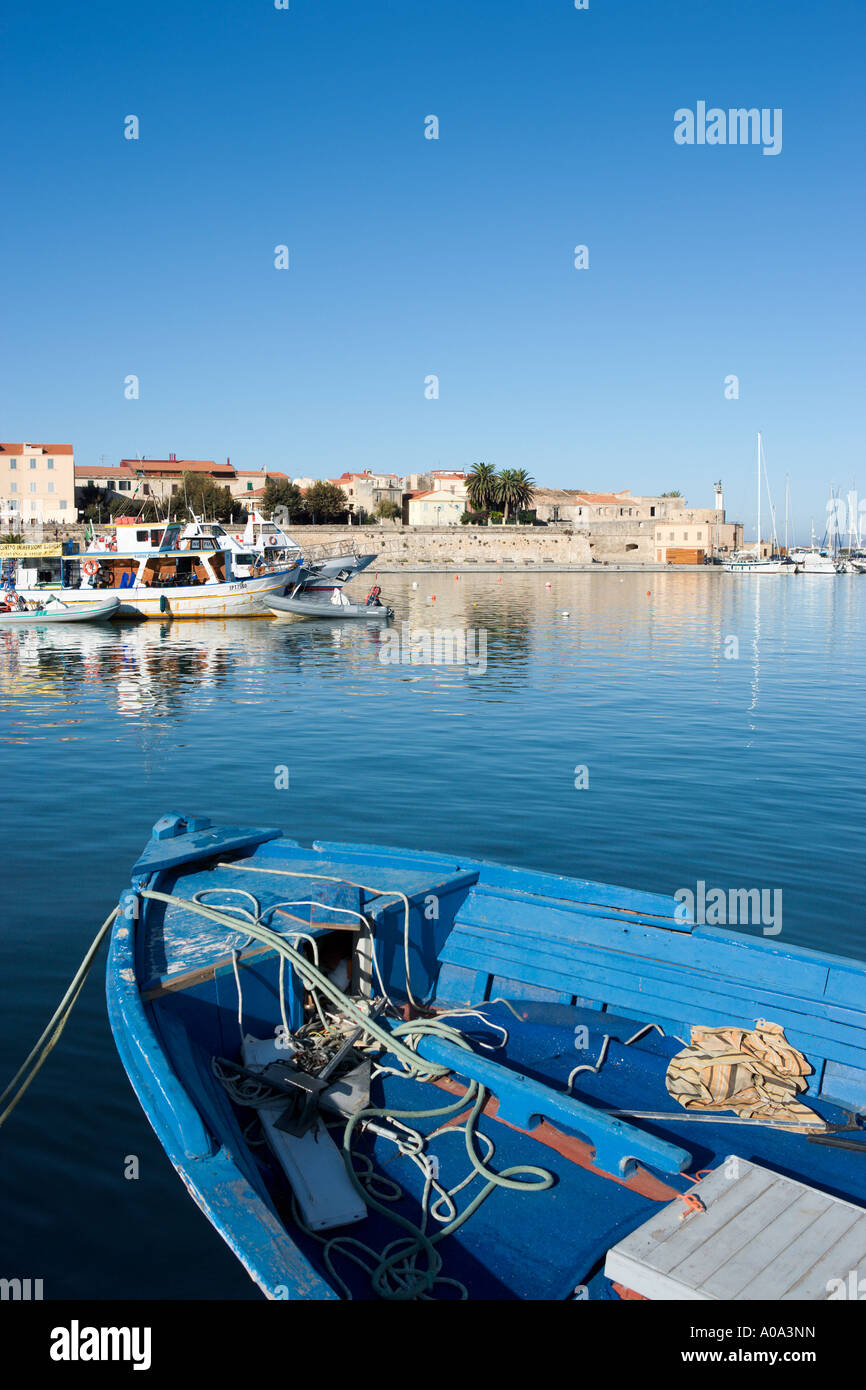 Traditional fishing boat in the harbour of the old town, Alghero, Sardinia, Italy Stock Photo