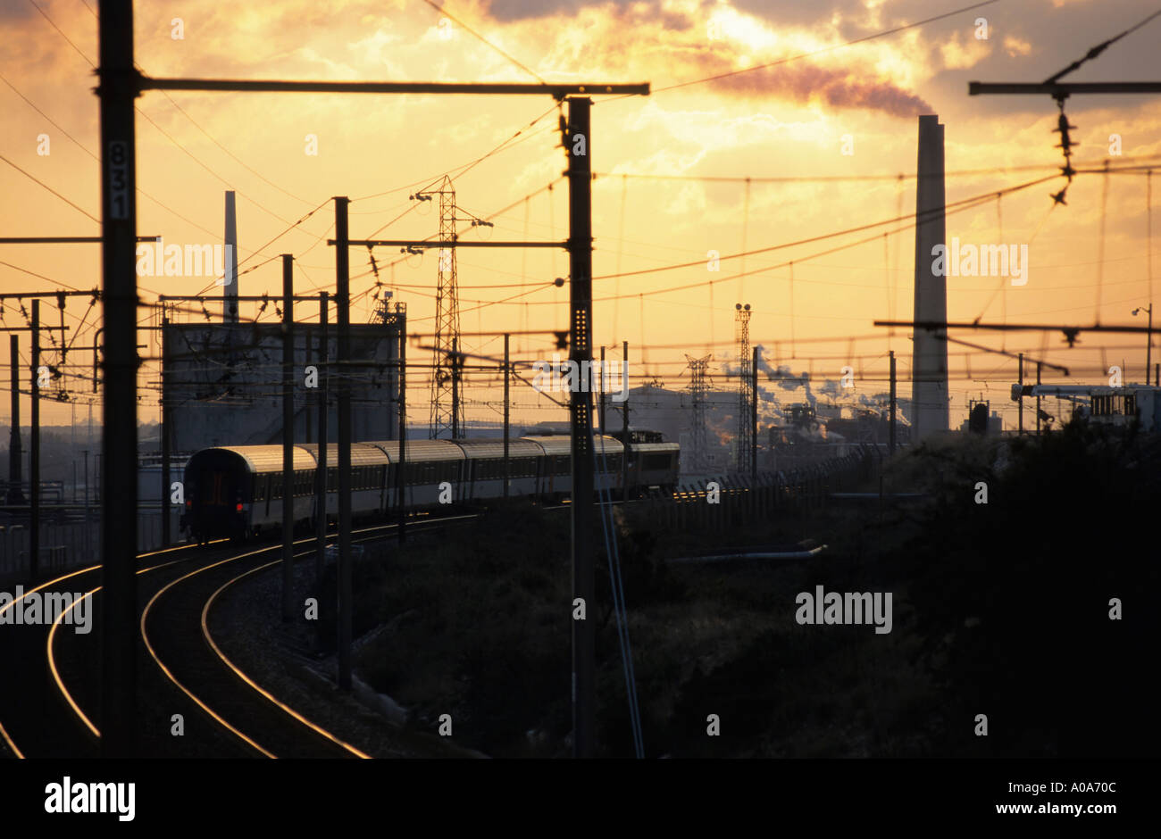 France Berre Train On Railways With Smoking Chimney Stock Photo