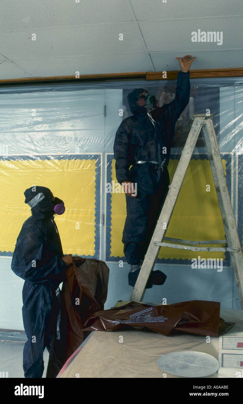 Workers Remove Abestos Ceiling Tile In Virginia School Stock Photo