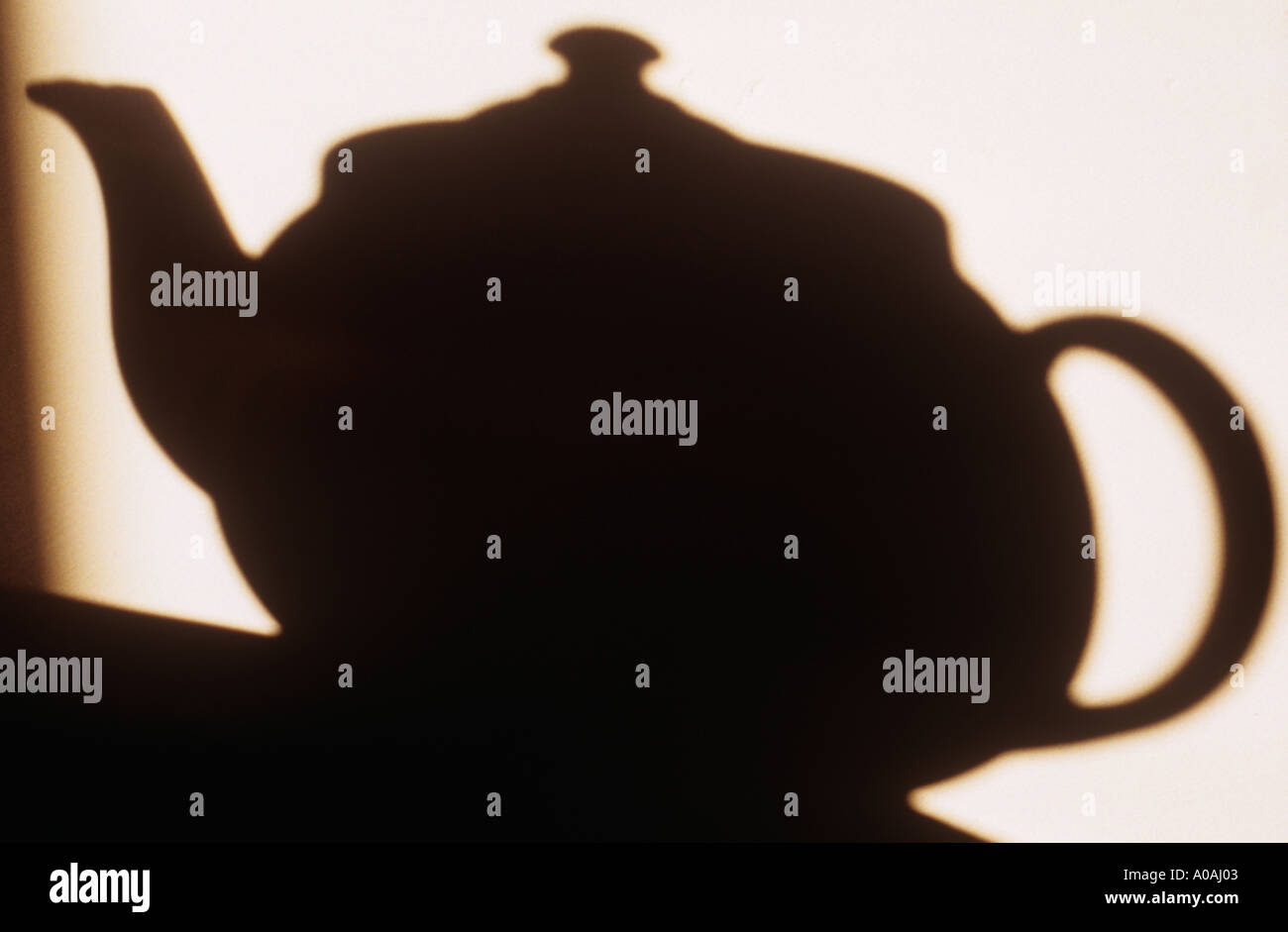 Shadow on wall of teapot standing on a table Stock Photo