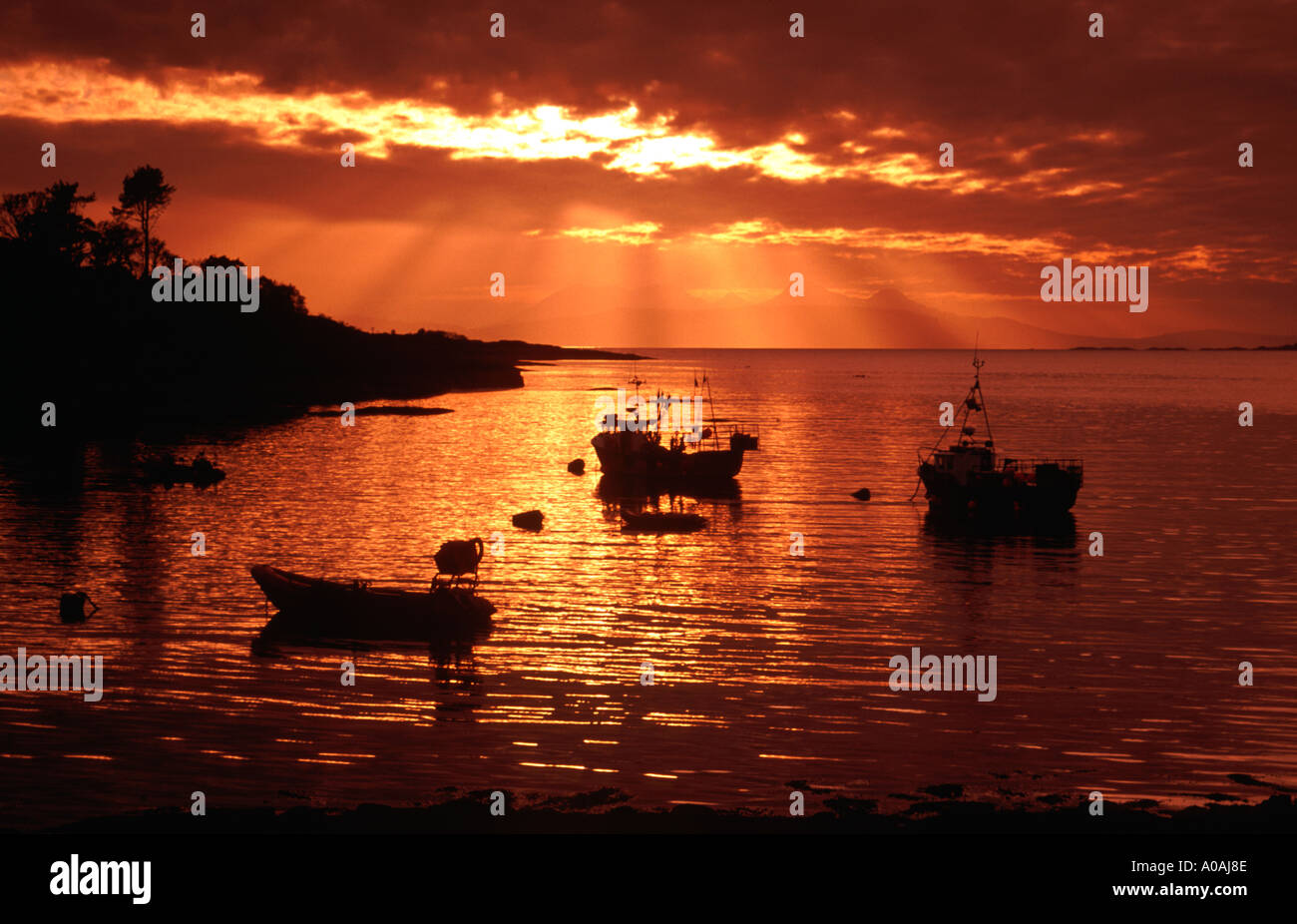 Boats on Loch Ailort Scottish Highlands at sunset Stock Photo