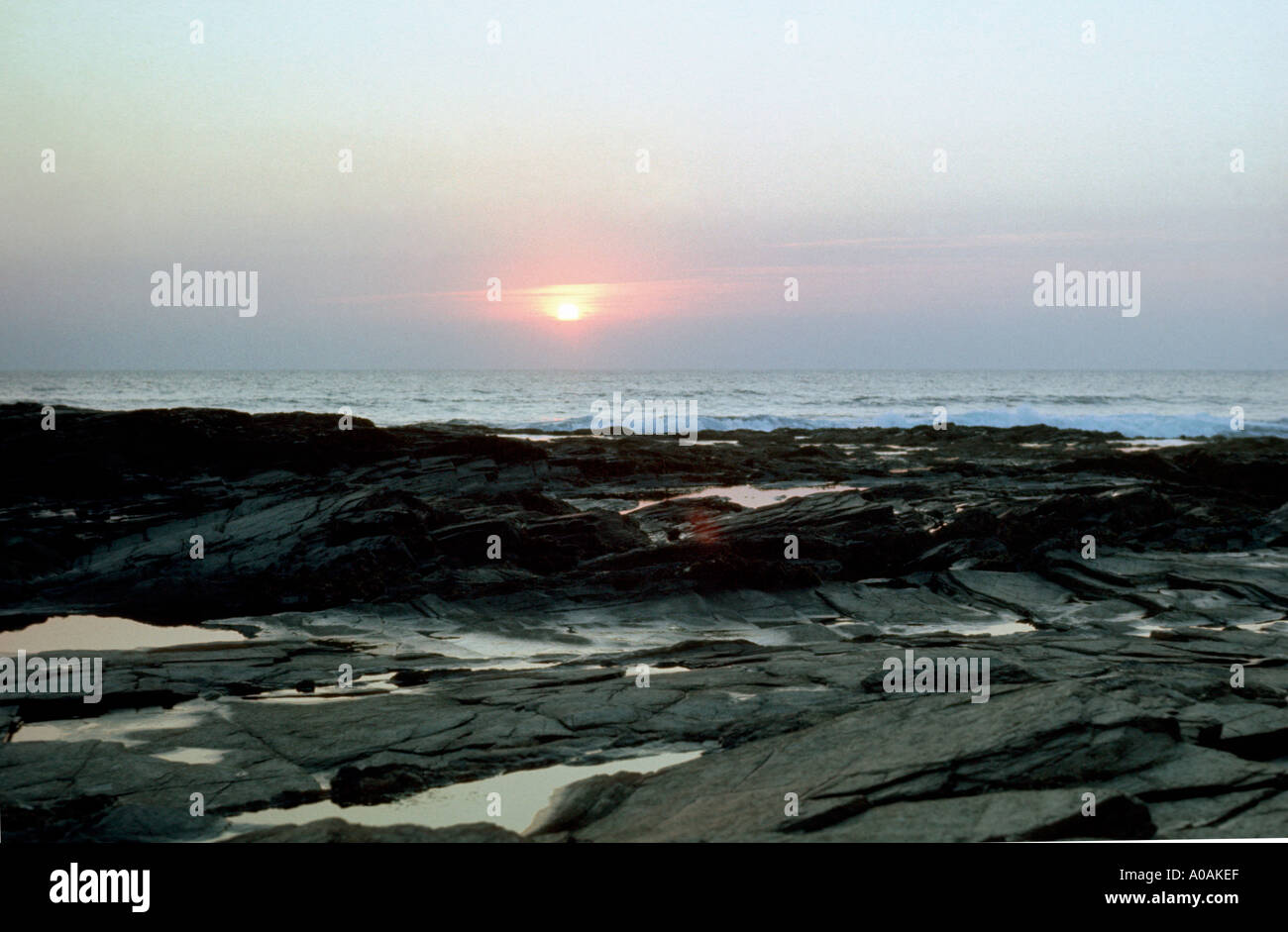 Sunset over the rocks at low tide Treyarnon Bay North Cornwall Stock Photo